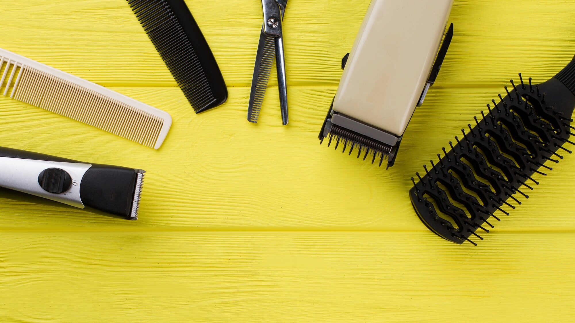 Hairdresser accessories on color background.